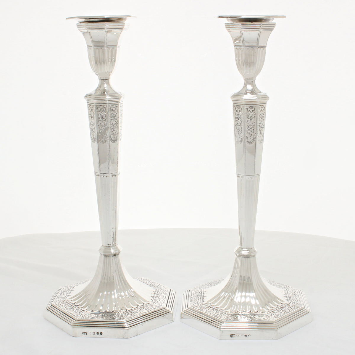 Pair of solid silver candlesticks with ornate decoration