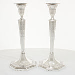 Pair of solid silver candlesticks with ornate decoration