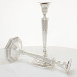 Pair of solid silver cast candlesticks with ornate decoration